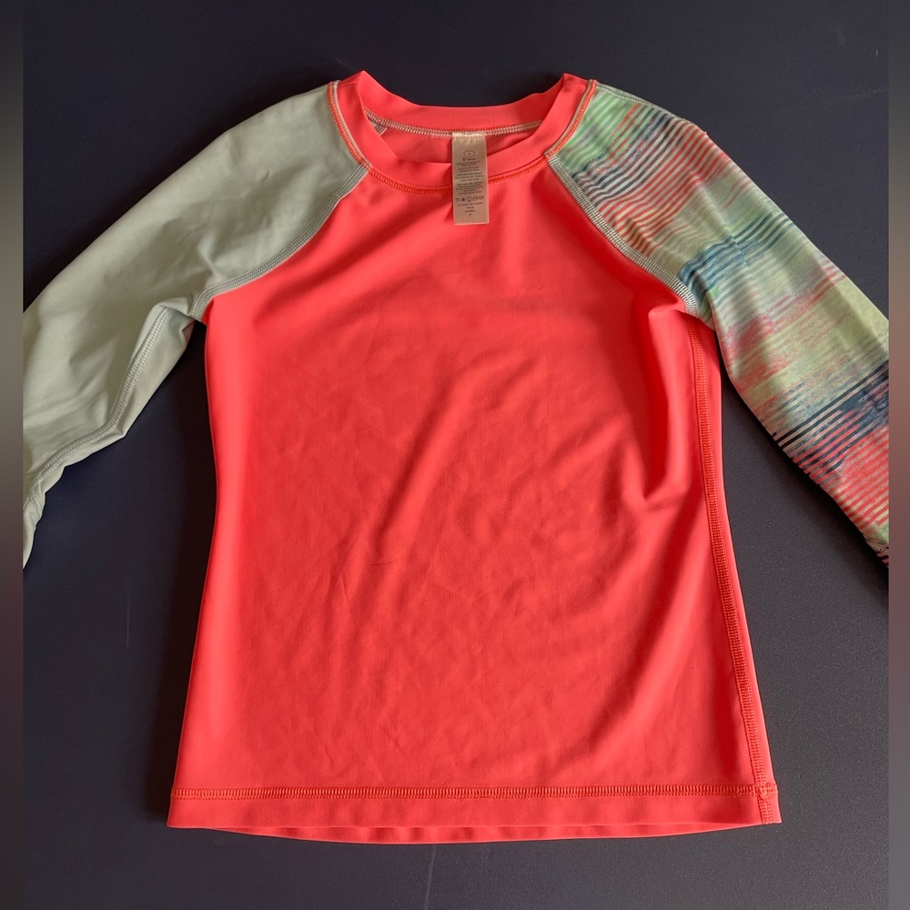 Like new, kids size 7 Ivivva rash guard. Neon pink with multi-color sleeves